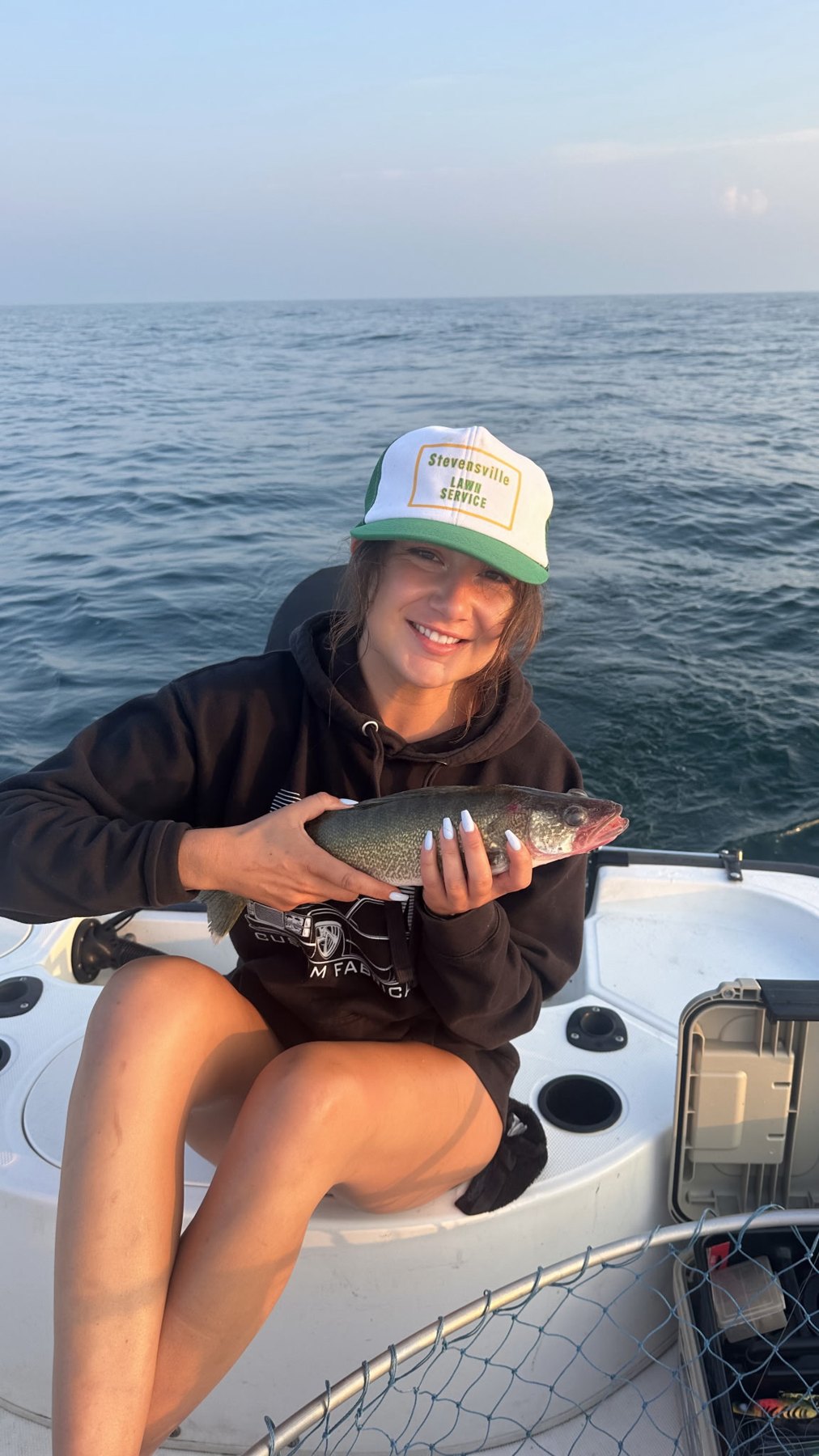 Nelly holding a walleye on the boat
