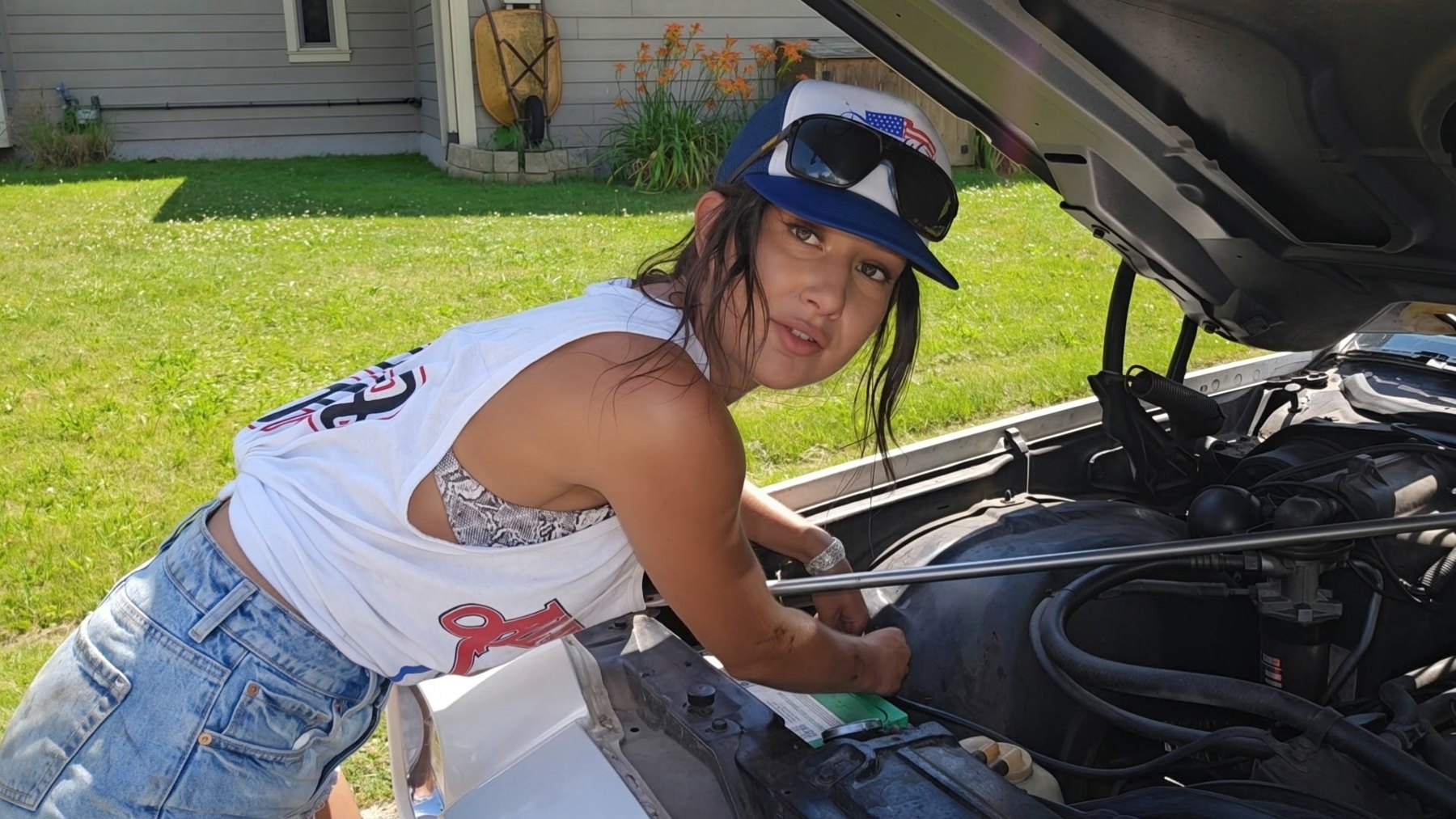 Nelly working under the hood of her squarebody